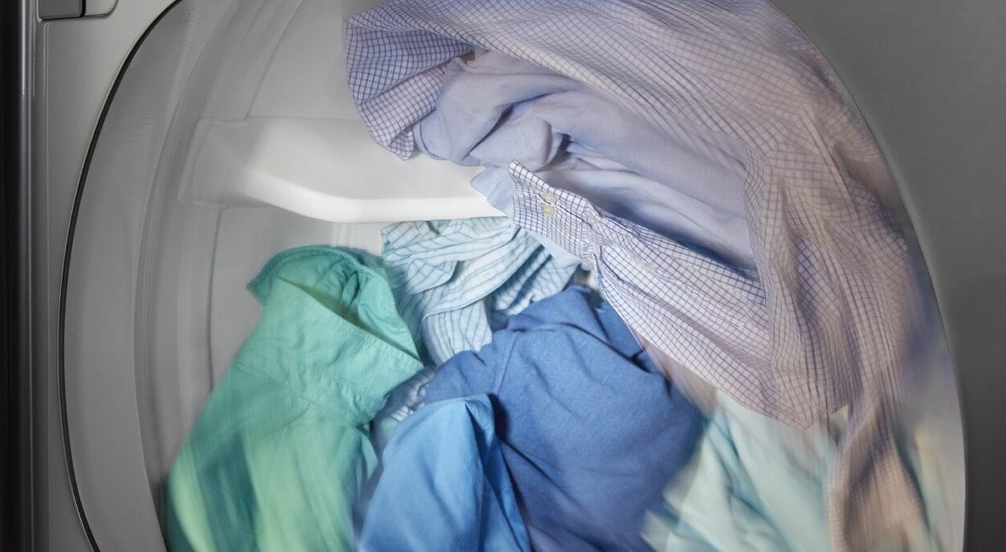 Clothing inside a dryer pictured in the Maytag tumble-drying guide.
