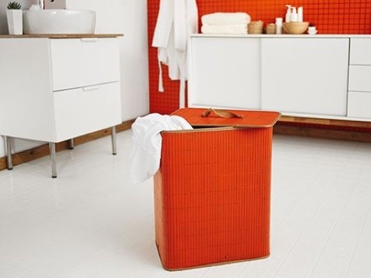 An orange laundry basket in the bathroom pictured in the source sorting guide.