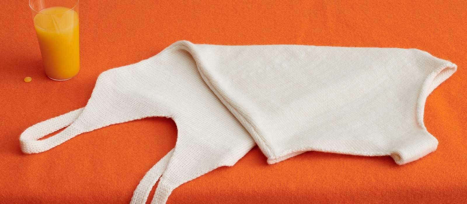 A white garment and fruit juice pictured in Woolmark's stain-removal guide.